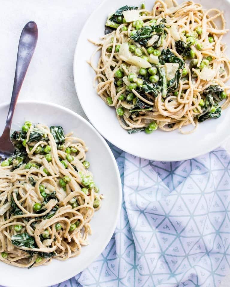 spicy tahini pasta with sauteed kale + peas + onion