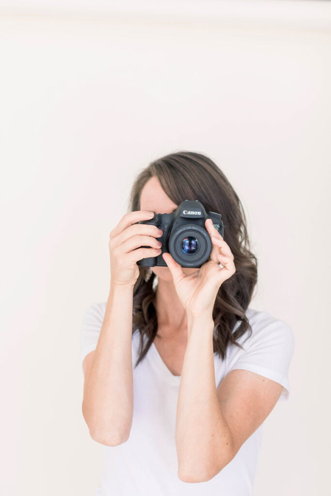 Gina Fontana holding up a camera to take photos