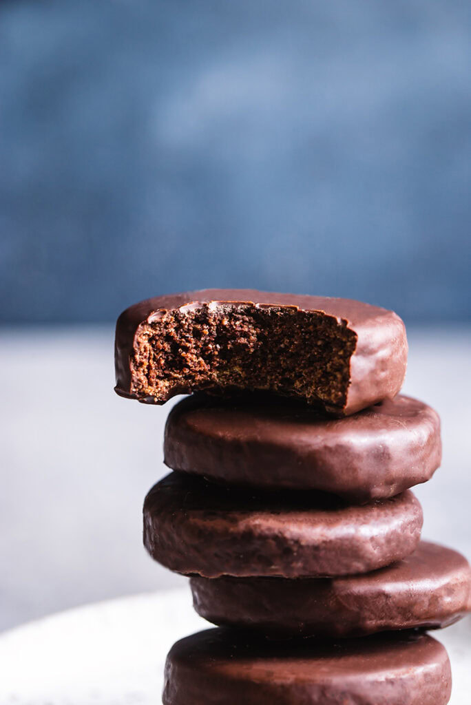 close up of a vertical stack of thin mint cookies with a bite taken out of the top one