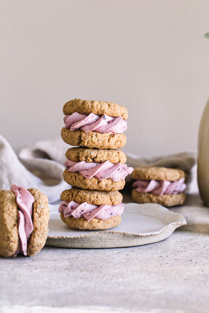 blackberry cream sandwich cookies stacked on top of one another on a plate