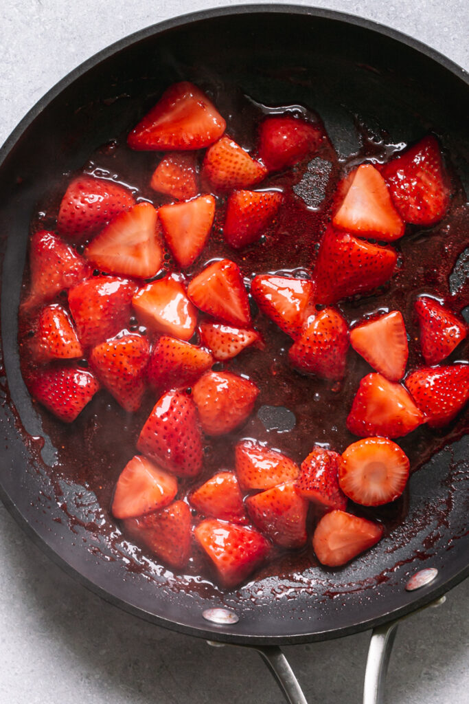 a skillet of juice sautéed strawberries