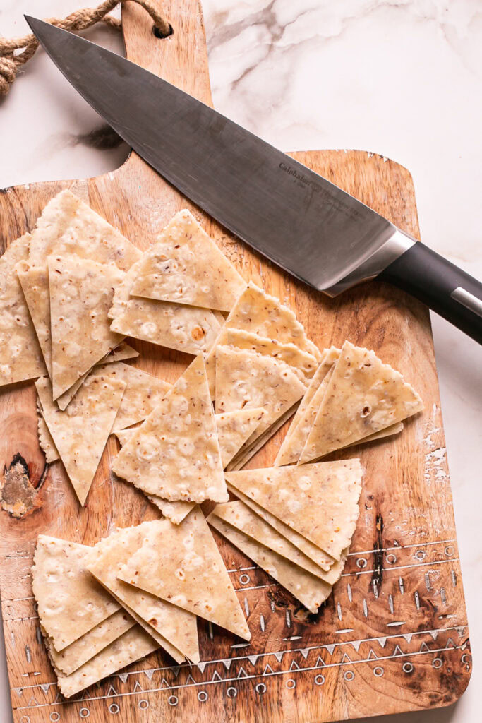 tortillas cut into triangles with a Calphalon knife on a cutting board