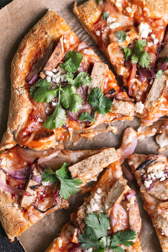 close up of Vegan BBQ Chicken Pizza sliced into pieces