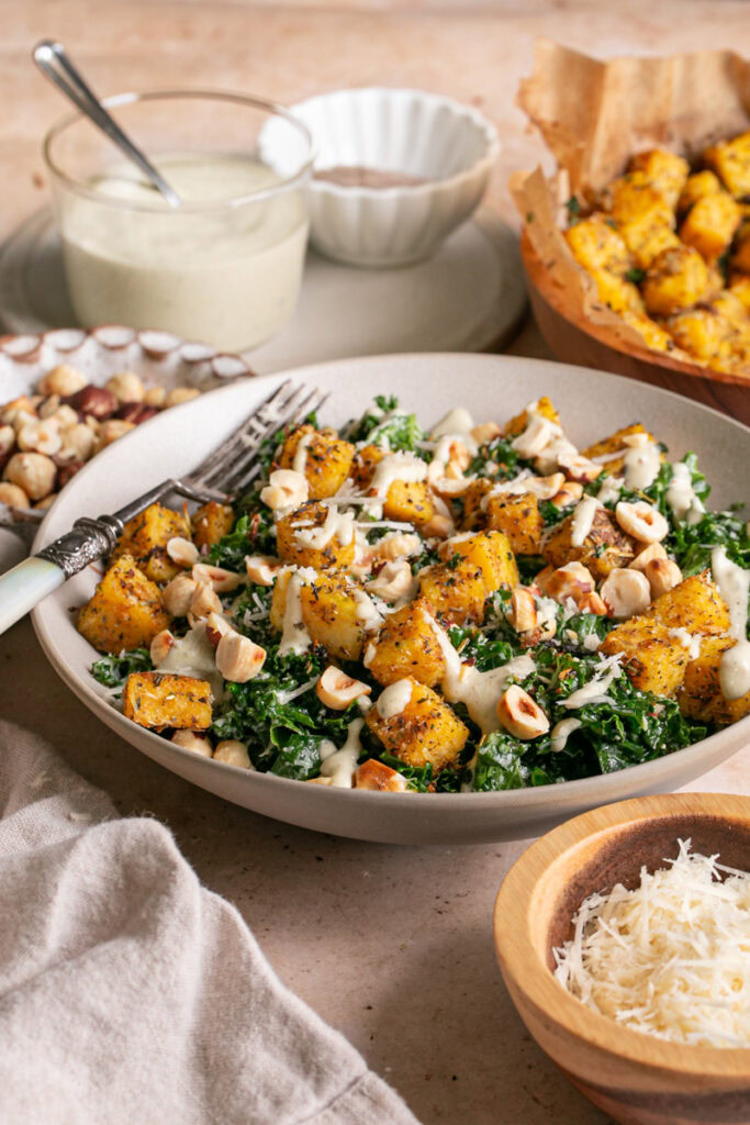 3/4 shot of Kale Caesar Salad with Polenta Croutons and Toasted Hazelnuts