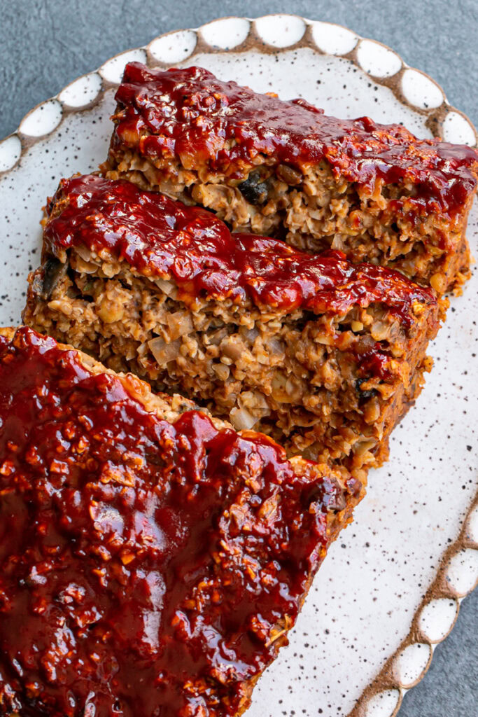 Vegan Gluten-Free Meatloaf on a platter with two pieces sliced