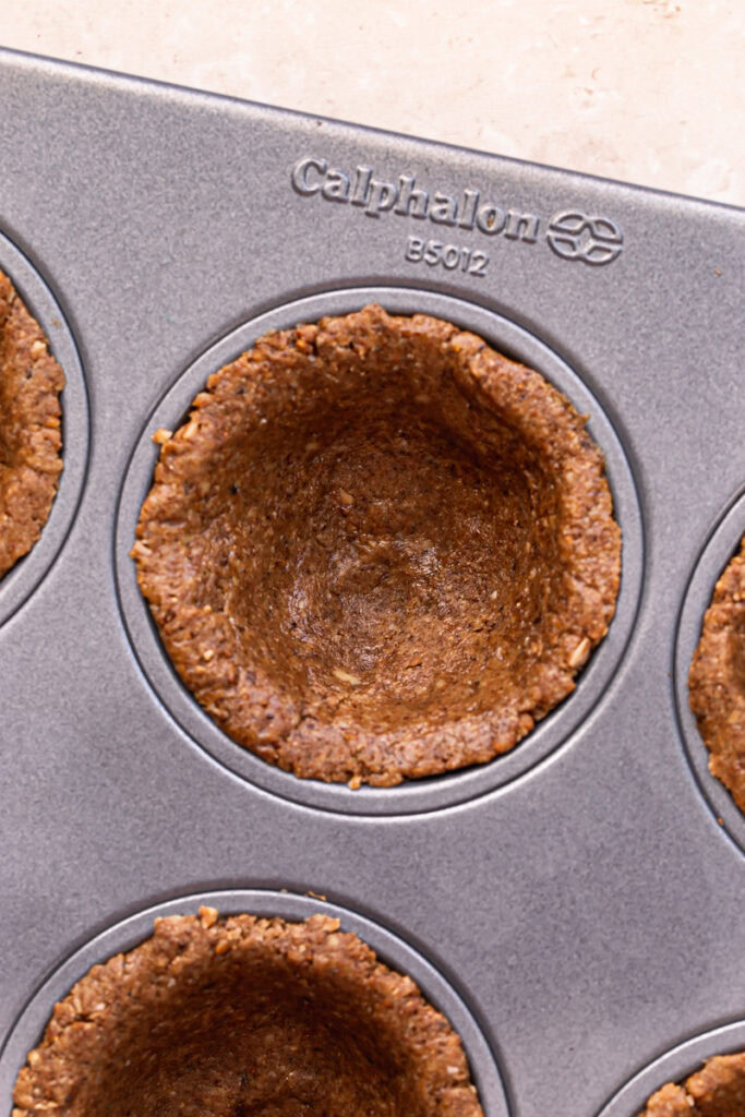 cookie dough pressed into a calphalon nonstick muffin pan